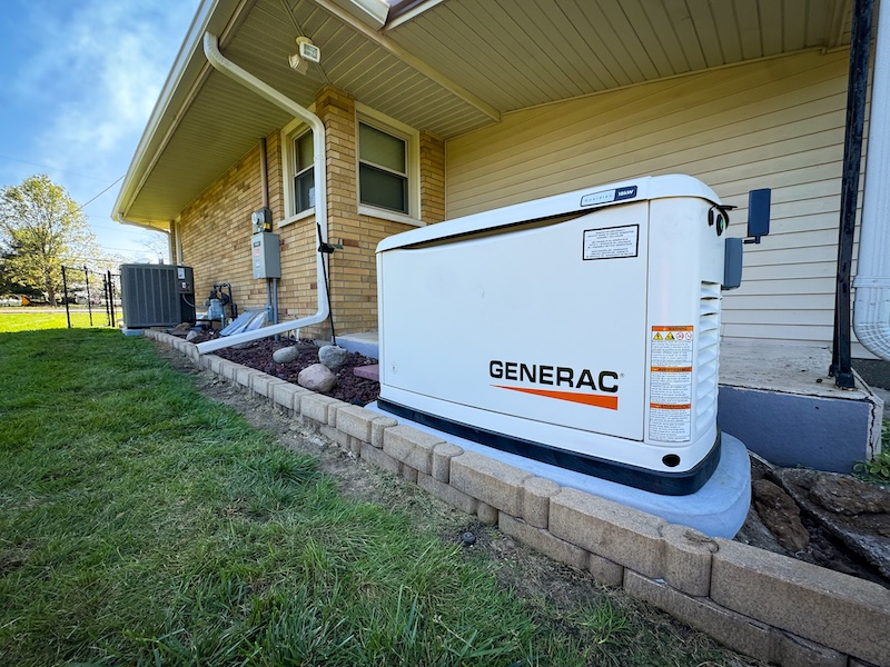 Whole home standby generator installed beside a home